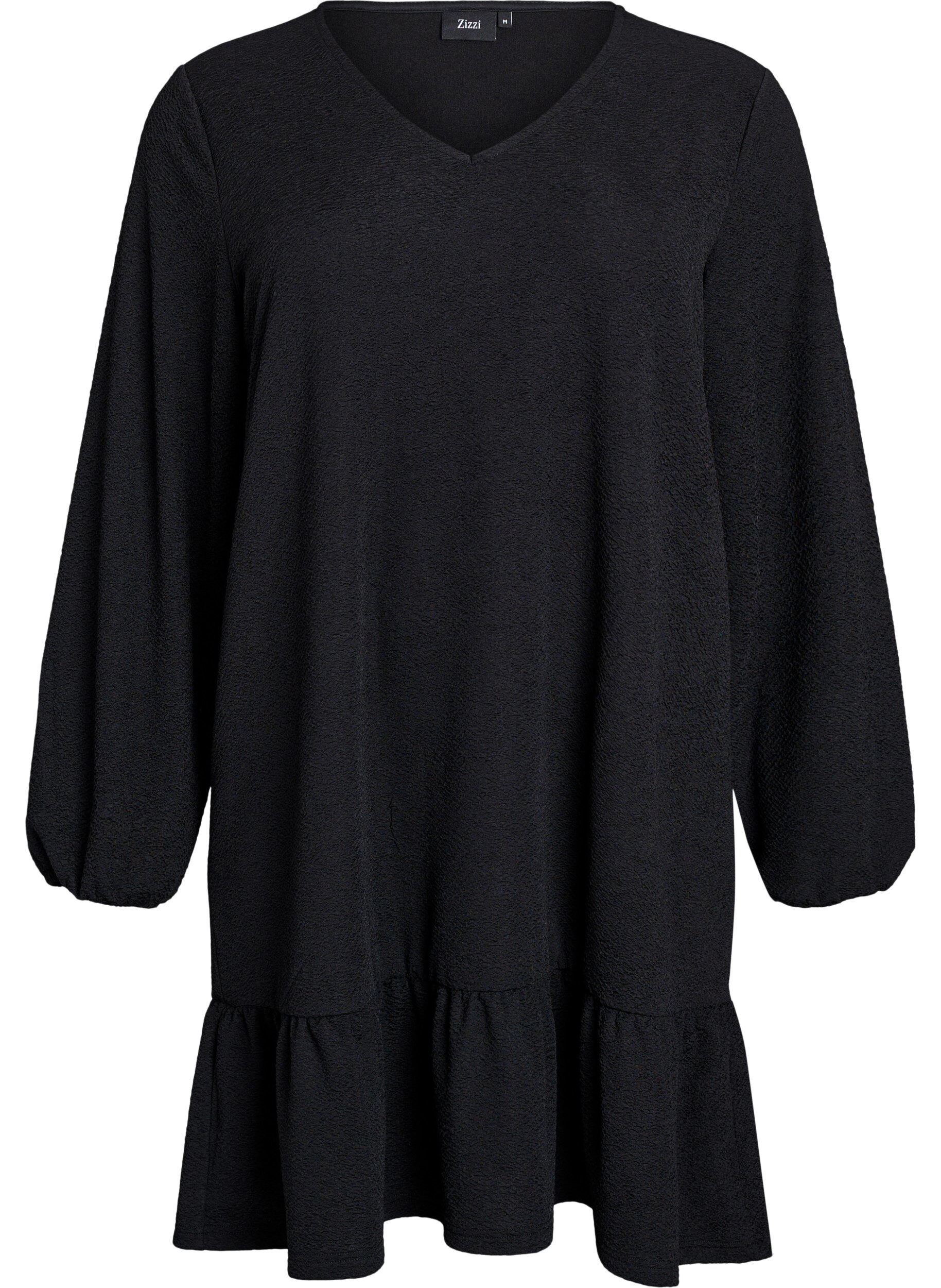 Kr&oacute;tka teksturowana sukienka z falbana u dolu