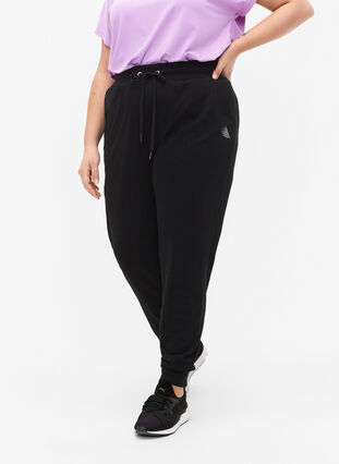 Luzne spodnie treningowe z kieszeniami, Black, Model image number 0