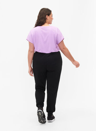 Luzne spodnie treningowe z kieszeniami, Black, Model image number 1